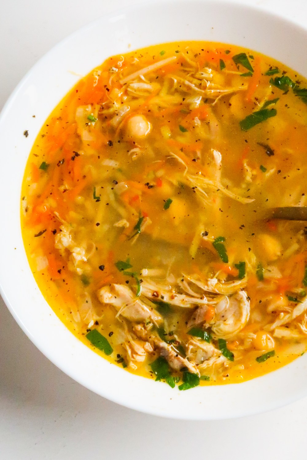 Nothing more comforting than a bowl of hearty homemade chicken soup! This is a delicious protein-packed easy healthy chicken soup recipe made with chickpeas, vegetables and noodles. This healthy soup recipe is ready in about 45 minutes from start to finish.