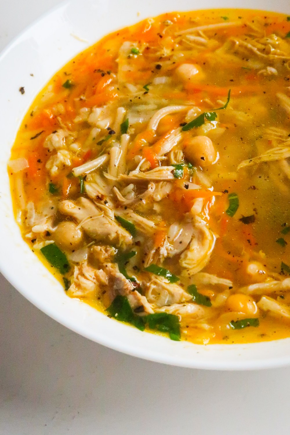 Nothing more comforting than a bowl of hearty homemade chicken soup! This is a delicious protein-packed easy healthy chicken soup recipe made with chickpeas, vegetables and noodles. This healthy soup recipe is ready in about 45 minutes from start to finish.