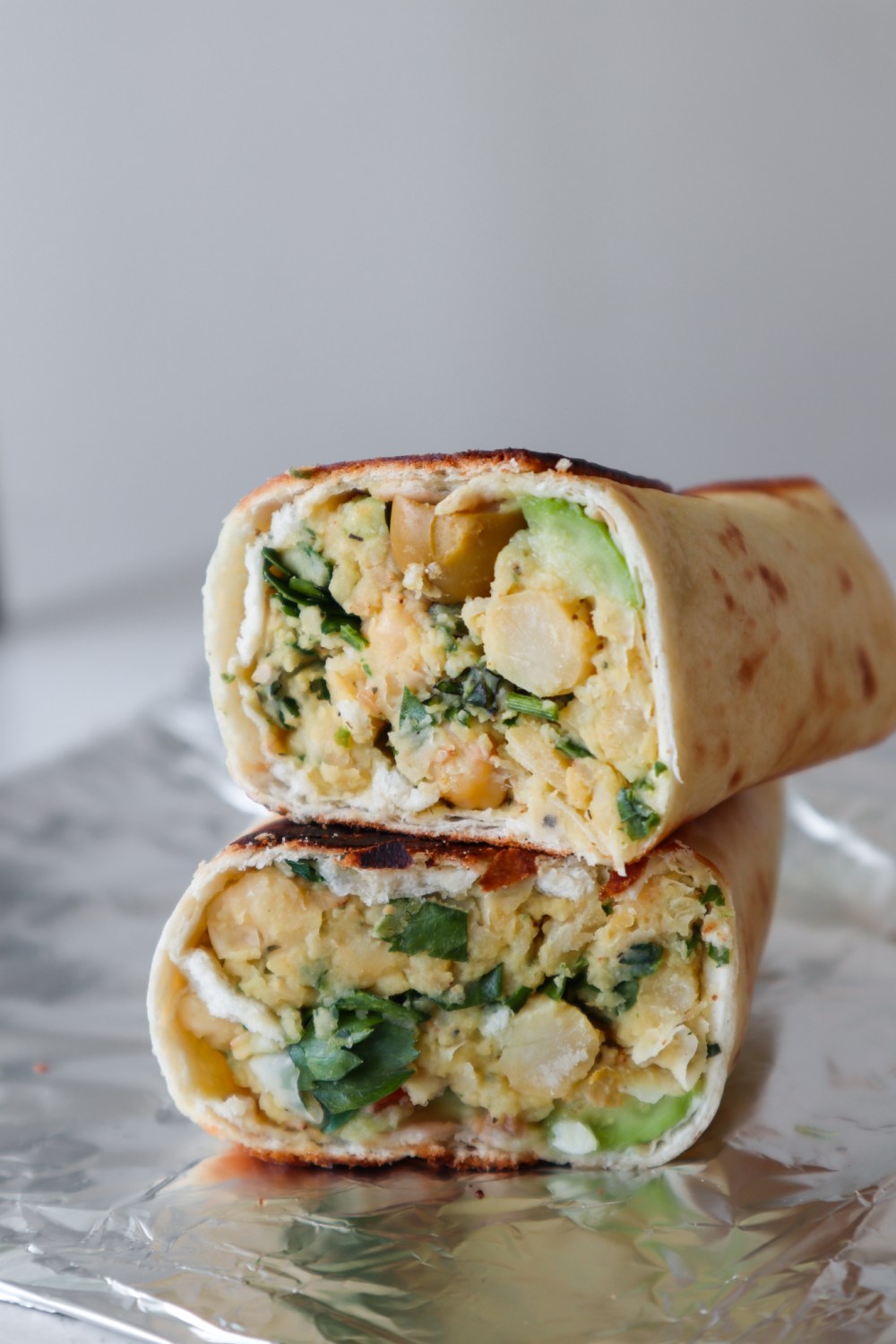 This vegan avocado chickpea wraps recipe is ready in about 15 minutes and such a delicious vegan dinner idea. Full of flavor spicy smashed chickpea wraps made with simple healthy ingredients like canned chickpeas, garlic, chili powder and avocado!