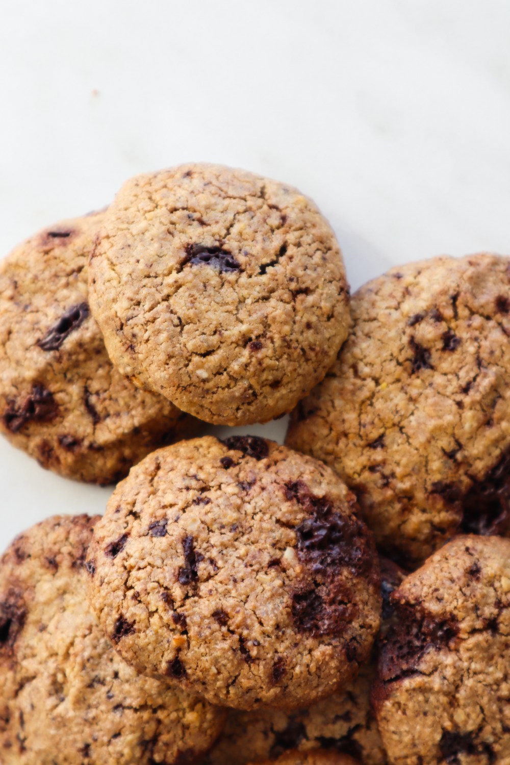 Learn how to make oatmeal cookies from scratch with this easy and healthy flourless oatmeal cookie recipe! To make these healthy cookies we’ll use gluten free oats, coconut sugar, an egg, coconut oil, some baking soda and some chocolate chips! Soft and chewy, kids love these - as a treat, or a healthy snack! These are seriously the best homemade oatmeal chocolate chip cookies!