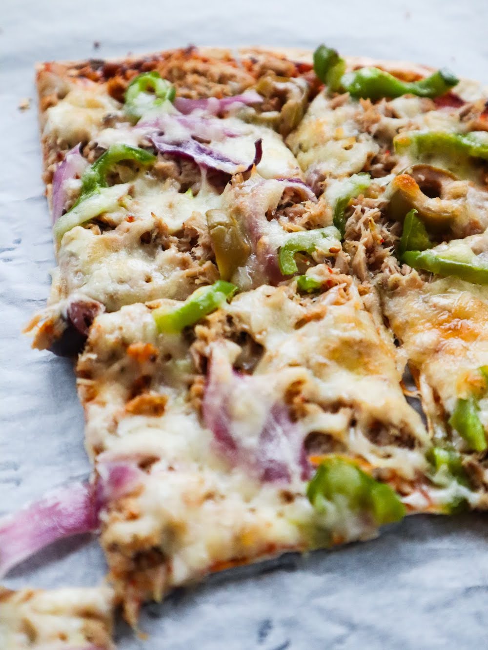 Easy Tuna Pizza Recipe! Grab some canned tuna and tortillas and make this delicious easy tuna pizza for dinner tonight! High protein and low in calories, this tuna recipe is a fairly healthy option as well.