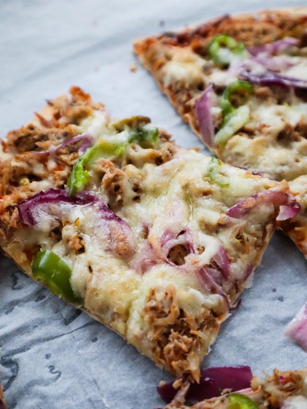 Easy Tuna Pizza Recipe! Grab some canned tuna and tortillas and make this delicious easy tuna pizza for dinner tonight! High protein and low in calories, this tuna recipe is a fairly healthy option as well.